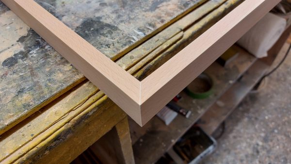 Detail of wooden picture frame being manufactured
